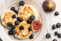 Above view of tasty breakfast: cheese pancakes with blueberry and figs