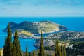 Above view to Assos village and beautiful blue sea. Cypress trees stands out in foreground. Kefalonia island, Greece