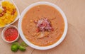 Above view of traditional Ecuadorian food called Encebollado, fish stew and ring onions inside, served with popcorn