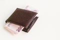 Turkish 200 Lira Banknotes with a leather wallet on white surface Royalty Free Stock Photo