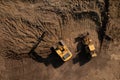 Above view of two heavy excavators during earth works