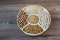 Uncooked dried chickpeas, wheat, rice and white beans in divided plate.Ashure Day Royalty Free Stock Photo