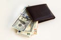 Us dollar and euro banknotes with a leather wallet on a white surface Royalty Free Stock Photo