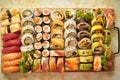Above view of various sushi and rolls placed on wooden board. Japanese food fest