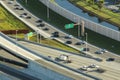 Above view of wide highway crossroads in Miami, Florida with slow driving cars during rush hour. USA transportation