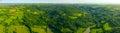 Aerial panoramic view of over green hilly landscape