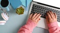 Above view woman hands typing on laptop computer at her office desk. Royalty Free Stock Photo