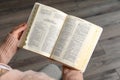 Above view of woman reading Bible indoors, closeup Royalty Free Stock Photo