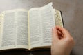 Above view of woman reading Bible at light grey table, closeup Royalty Free Stock Photo