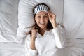 Above view woman wears striped eye mask feels rested fresh