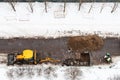 Above view of workers and tractor digging road Royalty Free Stock Photo