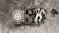 Overhead, drone, looking down on Male army officer in uniform resting on back of military vehicle Royalty Free Stock Photo