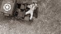 Overhead, drone, looking down on Male army officer in uniform resting on back of military vehicle