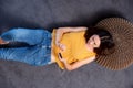 Above of woman lying on floor listening to music on mobile phone with earphones Royalty Free Stock Photo