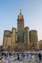 Abraj Al Bait Tower in Mecca, Saudi Arabia. Royal Clock Tower, blue sky scenery and pilgrims from around the world