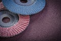 Abrasive flap wheels on sandpaper sheet top view Royalty Free Stock Photo