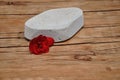 An abrasive stone to remove dry skin from heel with a red flower