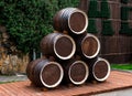 Abrau-Durso, wooden wine barrels made up of a pyramid on a platform of boards, in the background a stone wall overgrown with vines Royalty Free Stock Photo