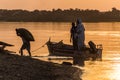 ABRI, SUDAN - FEBRUARY 25, 2019: People carrying bags from a boat on the river Nile in Abri, Sud
