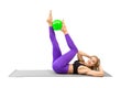 Abs training with small fit ball. Athletic beautiful smiling woman does crunches exercise lying on back indoors Royalty Free Stock Photo