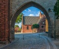 The Absalon Arch built between bishop`s palace and Gothic Roskilde Cathedral.Roskilde.Denmark Royalty Free Stock Photo