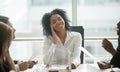Absent-minded distracted black businesswoman dreaming smiling at