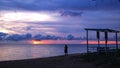 Colorful sunset view and silhouette's woman on the beach. Royalty Free Stock Photo