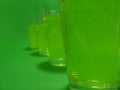 Absinthe in a transparent glass on a green background Royalty Free Stock Photo