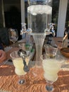 Absinth fountain with water and ice cube and four glasses and spoon Royalty Free Stock Photo