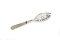 Absinth spoon with orifices on white background Royalty Free Stock Photo