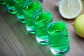 Absinthe shot glass sugar lemon wooden table Royalty Free Stock Photo