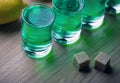 Absinthe shot glass sugar lemon wooden table Royalty Free Stock Photo