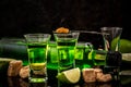 Absinthe shots with sugar cubes. absinthe poured into a glass. bottle of absinthe with brown sugar and lime  on black Royalty Free Stock Photo