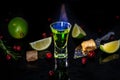 Absinthe shots with sugar cubes. absinthe poured into a glass. bottle of absinthe with brown sugar, cranberries and lime, Royalty Free Stock Photo