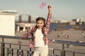 Absolutely thrilled. Happy party girl on urban background. Adorable girl holding prop glasses for party fun. Cute small