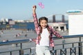 Absolutely thrilled. Happy party girl on urban background. Adorable girl holding prop glasses for party fun. Cute small