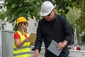 Male and female engineers at work on construction site