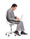 Absorbed in his work. A focused young executive working on his laptop while isolated on white. Royalty Free Stock Photo