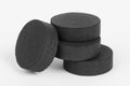 Absorbent, activated charcoal tablets on a white background Royalty Free Stock Photo
