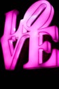 Abstact blurred Plastic pink sign of word LOVE on black background Royalty Free Stock Photo