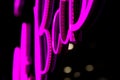 Abstact proton purple neon sign on black background Royalty Free Stock Photo