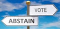 Abstain and vote as different choices in life - pictured as words Abstain, vote on road signs pointing at opposite ways to show