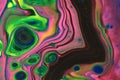 Neon pink and green steps lead to a metallic black river in this abstract background.