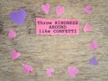 Inspirational Quote Good Vibes Concept - Throw kindness around like confetti text on torn paper with hearts background.
