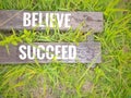 Inspirational motivational quote concept - Believe succeed on wooden plank with nature background. Royalty Free Stock Photo