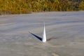 Abstract aerial view of church tower with cross and shadow, flooded by copper mining residuals and mud Royalty Free Stock Photo