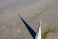 Abstract aerial view of church tower with cross and shadow, flooded by copper mining residuals and mud Royalty Free Stock Photo