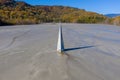 Abstract aerial view of church tower with cross and shadow, flooded by copper mining residuals and mud Royalty Free Stock Photo