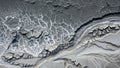 Cracked earth texture from aerial view showing dry mud and water channels Royalty Free Stock Photo