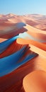 Abstract aerial views of desert ocean landscape in orange and blue. Sand dunes and swirling waves wallpaper. Royalty Free Stock Photo